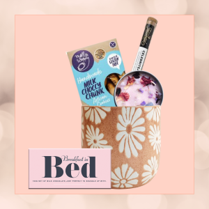 Candlelight Bliss gift set in an eco-friendly plant pot, featuring a crystal candle, chocolate bar, artisan cookies, and Teassentials tea, accompanied by a packet of seeds, wrapped in sustainable materials."