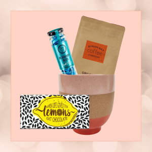 Coffee Connoisseur gift set in an eco-friendly plant pot, featuring Byron Bay coffee, rock candy, and a chocolate bar, accompanied by a packet of seeds, wrapped in sustainable materials."